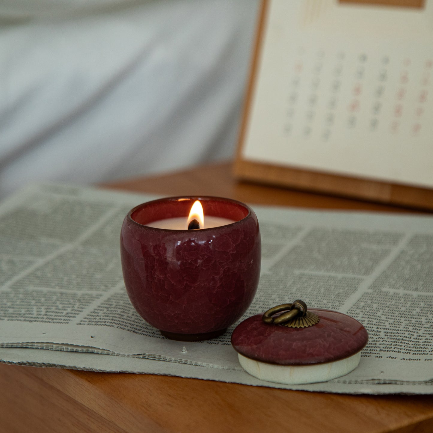 Candle in ceramic tea container with craquelé – rose red