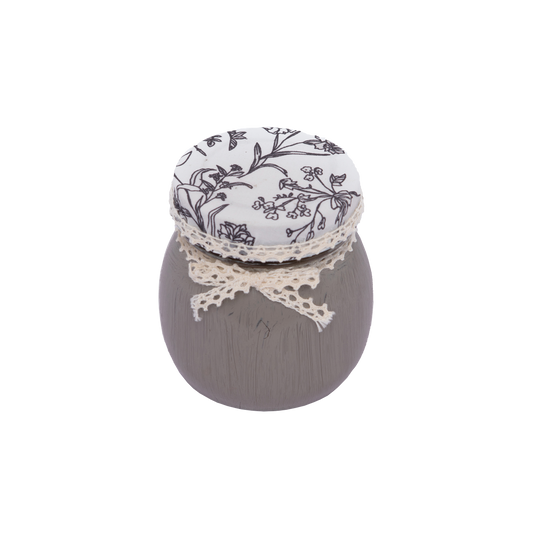 Scented candle in glass container with lace lid 